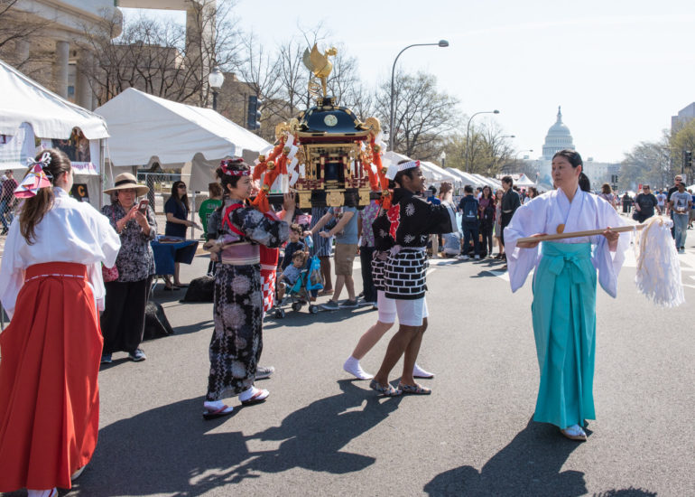 2018 Sakura Matsuri - Reverend Kuniko Kanawa leads students carrying a shrine in front of the U.S. Capitol Building.