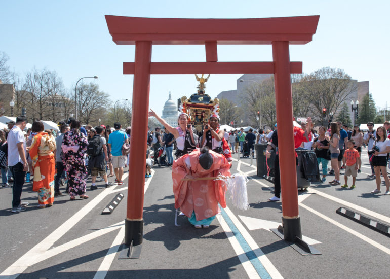 2018 Sakura Matsuri - Reverend Kuniko Kanawa leads students carrying a shrine in front of the U.S. Capitol Building.