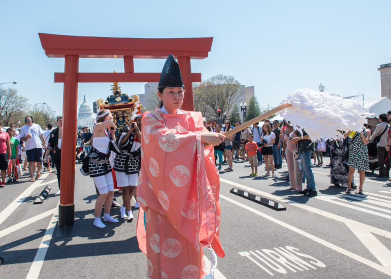 2018 Sakura Matsuri - Reverend Kuniko Kanawa leads students carrying a shrine in front of the U.S. Capitol Building.