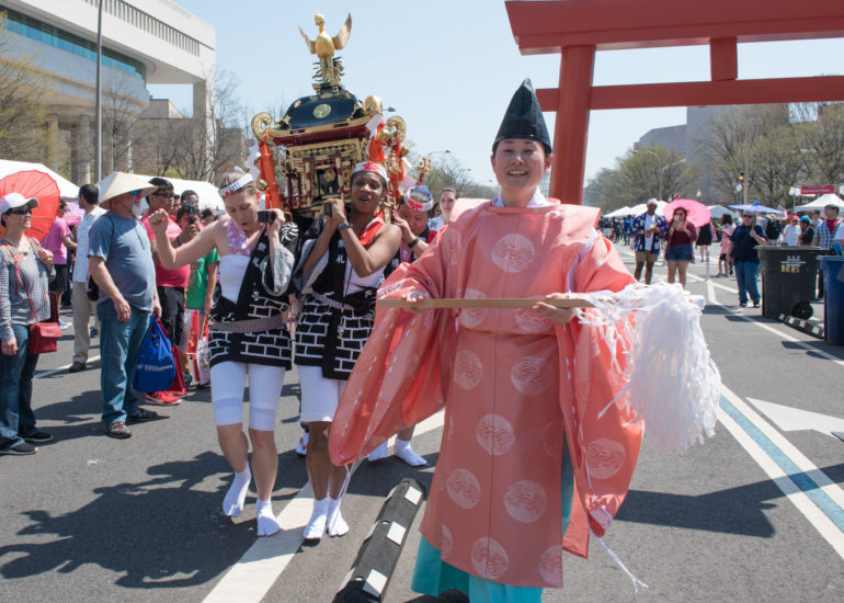 2018 Sakura Matsuri - Reverend Kuniko Kanawa leads students carrying a shrine in front of the U.S. Capitol Building.