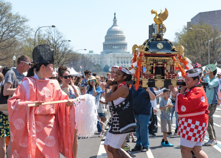 2018 Sakura Matsuri - Reverend Kuniko Kanawa leads students carrying a shrine in front of the U.S. Capitol Building.