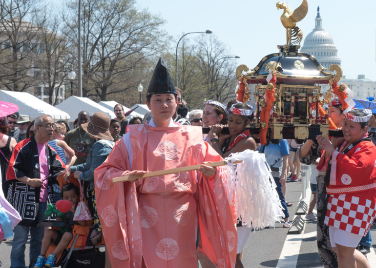 2018 Sakura Matsuri - Reverend Kuniko Kanawa leads students carrying a shrine in front of the U.S. Capitol Building.